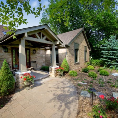 Exterior Portico Addition with Beams and Natural Stone