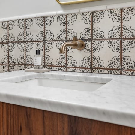 Quartz Counter Top on a Modern Vanity with Gold Pulls