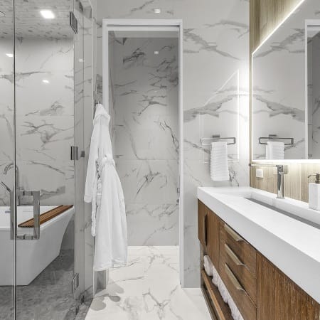 Looking into Water Closet with Adjacent Floating Vanity and Wet Room