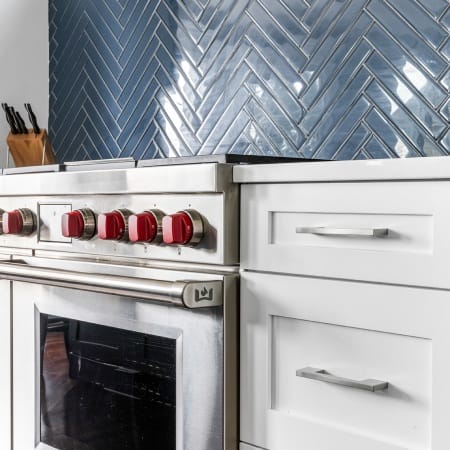 Blue Herringbone Subway Tile Above Wolf Oven