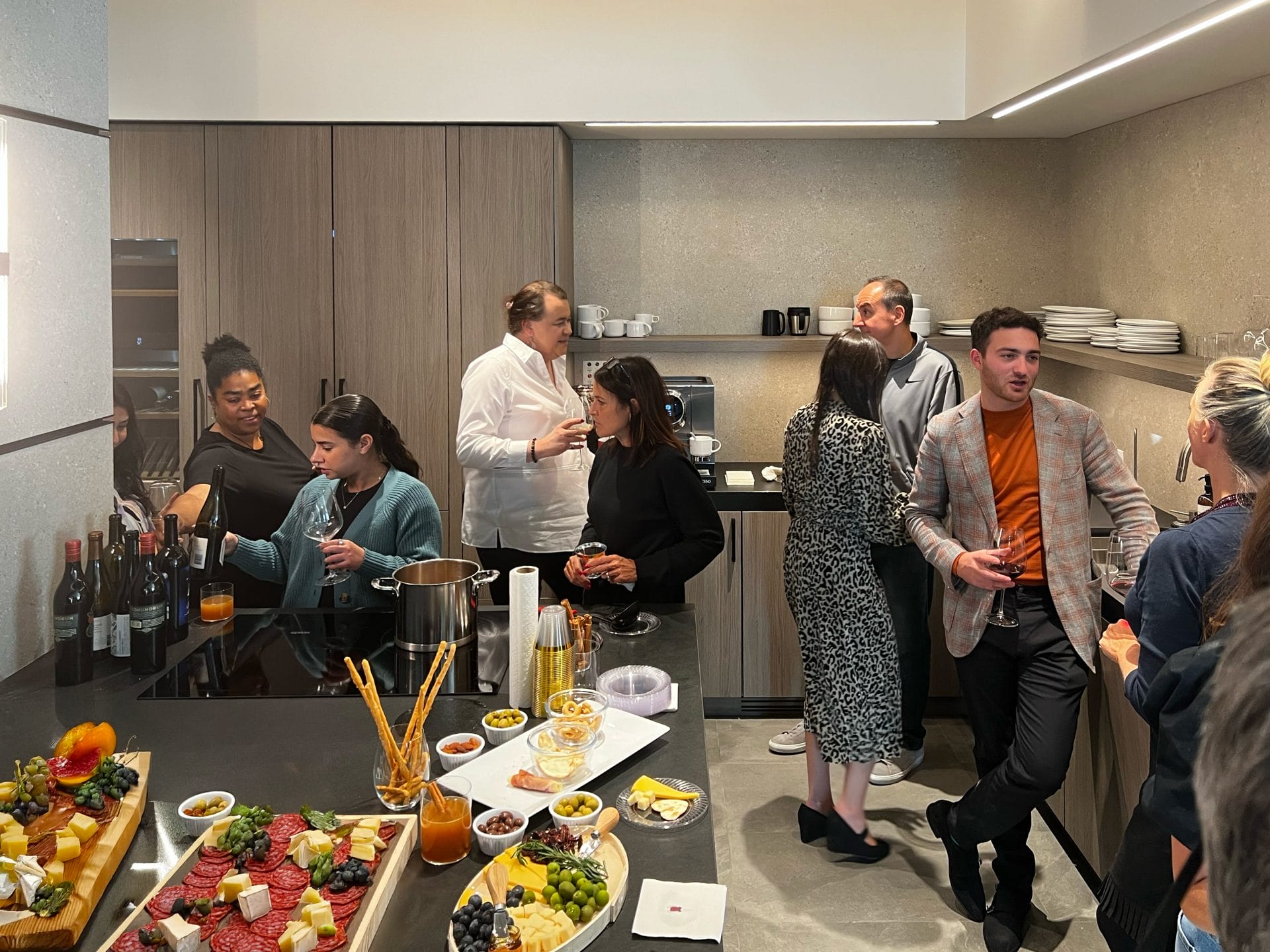 Group Of People Socializing In A Kitchen