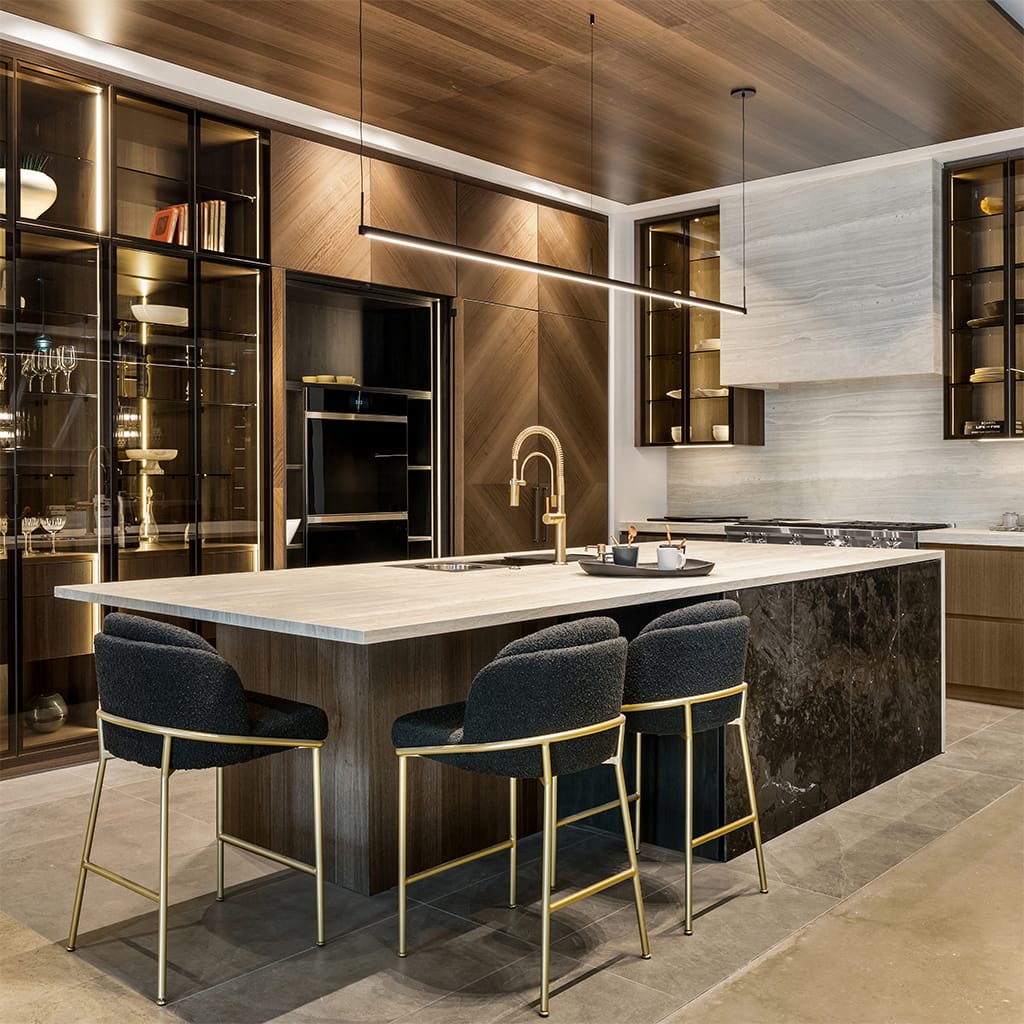 Kitchen With Sleek Wood Finishes And Gold-accented Stools